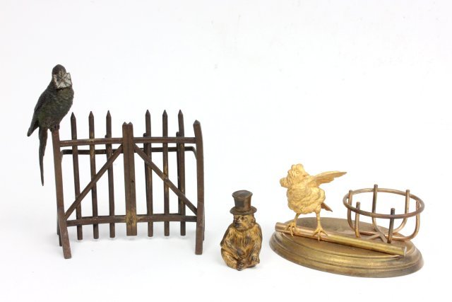 Metal desk pieces: Including 1 - cold painted bronze "Bird" letter holder, approx. 7" W. 1 - gilt metal desk tray. 1 - monkey lighter, gilding worn. Wear to paint throughout. From the estate of Chris Peckham.