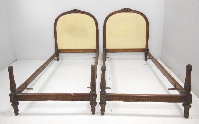 Pair of French single beds, carved walnut: Early 20thc, complete with footboards and rails 49 1/4"H x 40 1/2"W, one post has water damage (From the Estate of Chris Peckham)