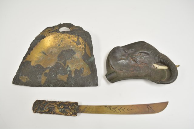 Japanese metalware: Including 1- letter opener, 1 - silent butler, approx. 8.5" W and 1 - elephant tray, approx. 6.5" W and 1 table scrape. From the estate of Chris Peckham.