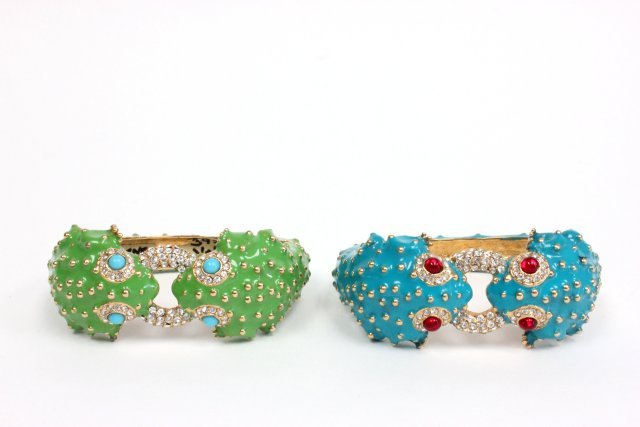 Pair of Ciner enamel frog bracelets: Approx. 2 bracelets, one with green enamel and one with blue. Both bracelets crafted from 18k Gold overly with clear Czechoslovakian glass. From the estate of Anita Stern, owner of This-N-That antique