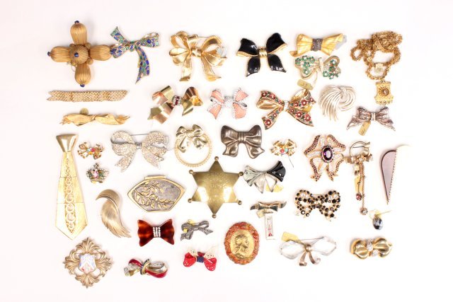 Gold colored, sterling & vintage bow motif pins: Includes pieces from Kenneth J Lane and MiMi. Approx. 25 pins. From the estate of Anita Stern, owner of This-N-That antiques store, NYC.