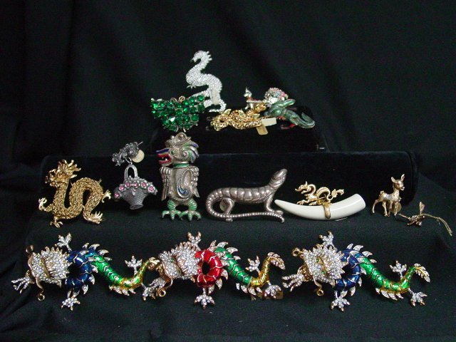Costume jewelry brooch lot 15 pieces: Includes a Kenneth Lane dragon brooch with clear rhinestones and black enamel. Early mark. Also includes bone, enamel, sterling and rhinestone brooches. From the estate of Anita Stern, owner of This-N