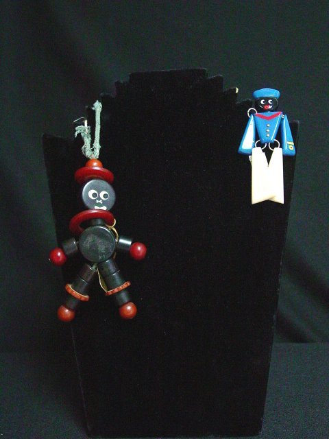 Bakelite crib toy and sailor brooch: Approx. 2 pieces including a bakelite black and rust colored crib toy approx. 4" long. Bakelite jointed sailor brooch with painted details. Approx. 3 1/4" long.