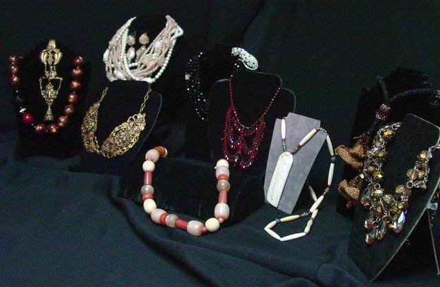 Costume jewelry 9 pieces: Includes Kenneth Lane black mutli-faceted beaded necklace joined together by green eyed, pave rhinestone panther. Early mark, 18" long. Miriam Haskell red beaded necklace, approx. 15" long, 3" additio