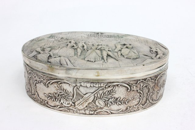Continental silver repousse box: Interior scene on top, people dancing and floral motifs all around box. Inscribed inside Alta Rockefeller and on bottom A.R. January 17, 1901. Approx. 2"H x 6 1/4"W x 4 3/4 D", 354.5 grams, 11.3 ozt. 