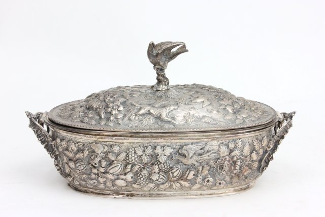 19th C. Sterling Kirk & Son Covered Casserole: Unmarked. Repousse motif with fruit & animals, bird finial with silver insert. Approx. 7" H x 12 1/2" long. Approx. 1853 grams, 593 ozt . From the Estate of Chris Peckham