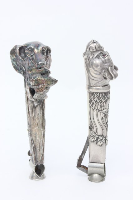 2 Continental Silver Cigar Cutters: Figural cutters depicting dogs. Approx. 5" long. From the Estate of Chris Peckham