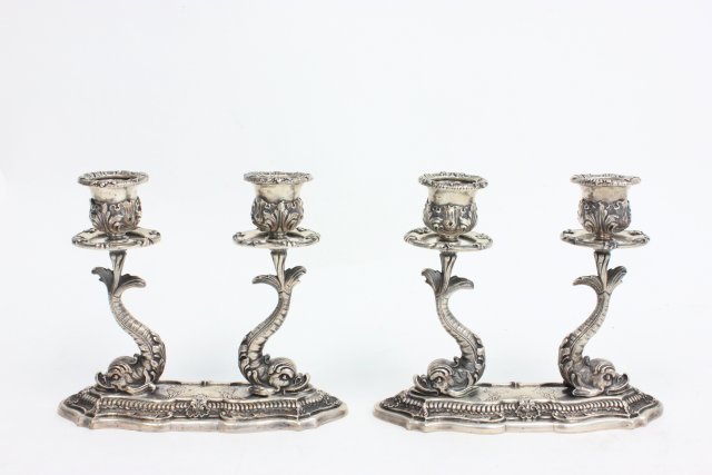Pair Buccellati 800 Silver Double Candlesticks: With dolphins. Approx. 5 1/4" H, 6 1/4" W. Approx. weight 1137 grams, 36.3 ozt From the Estate of Chris Peckham