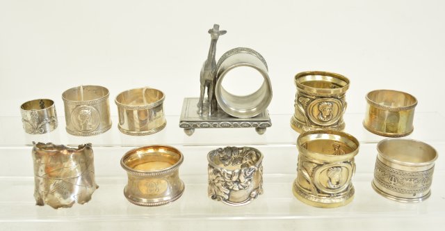 11 napkin rings including Sterling: Including figural, floral, Sterling, and Victorian pieces. From the estate of Chris Peckham.