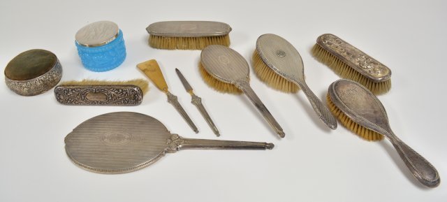 11 various sterling silver vanity pieces: Including 6 brushes, mirror, pin cushion, blue glass powder jar, shoe horn and nail file. From the Estate of Chris Peckham