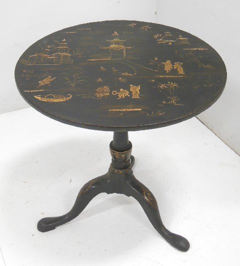 George III style Japanese tilt top table: Chinoiserie decorated black lacquer. Approx. 27.5" H. 2 legs reinforced. Missing wedge. Decoration slightly worn. From the estate of Chris Peckham.