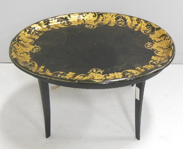 Victorian gilt decorated lacquer tray on stand: Mid 19th c. Approx. 18.5" H x 30.25" W x 25.25" D. Craqueleur edges chipped. From the estate of Chris Peckham.