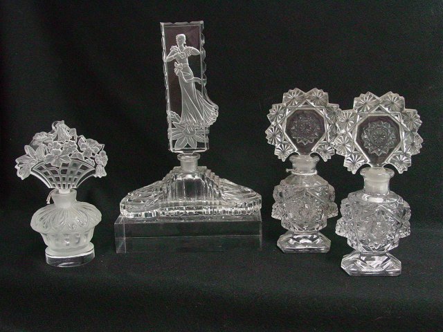 Pressed and intaglio glass perfume bottles: Approx. 4 pieces. From the estate of Anita Stern, owner of This-N-That antiques store, NYC.