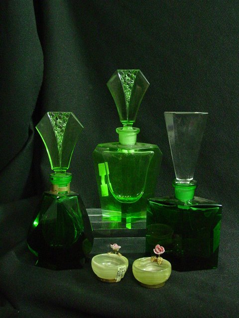 Crystal perfume bottles and flower ring holders: Approx. 5 pieces including 3 emerald crystal bottles and two flower ring holders. From the estate of Anita Stern, owner of This-N-That antiques store, NYC.