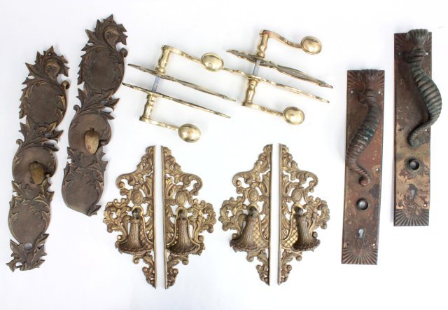 Antique bronze & brass door handles and knockers: Including: 2 pair with wheat sheaf knockers; a pair of brass w/key lock faces; a pair with scroll design and thumb push handles; and a pair w/ram's horn design.(From the Estate of Chris Peckham)