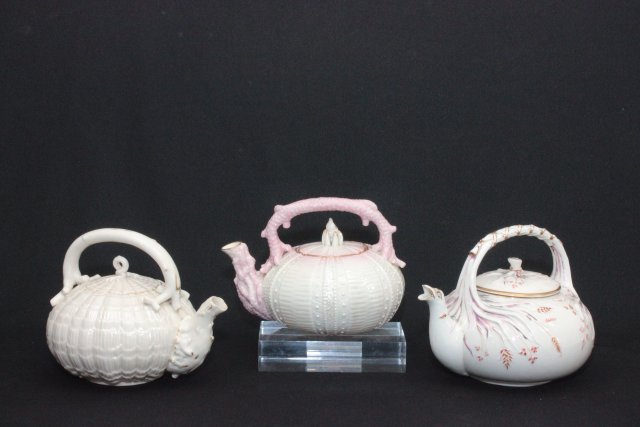 Lot of 3 Belleek Teapots: Including Echinus Egg Shell with faded gilt, Grassware tea kettle with damage on wide opening and Echinus teapot. Tallest piece approx. 6 in. h x 8 in. w. 19th century.