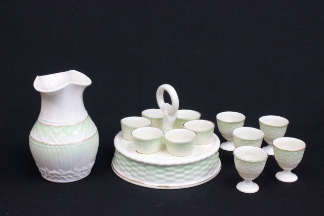 Belleek Sydney Tea Ware Egg Cups: Sydney Tea Ware egg cruit stand with 11 egg cups and vase. Green tinted and weave pattern. 13 pieces.