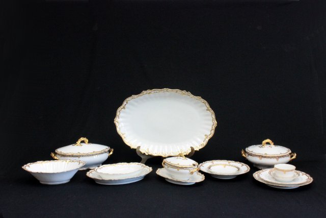 Limoges French porcelain dinnerware set: 70 pieces, gilded consists of 12 cups, 12 9 3/4" plates (2 with chips) 12-9" soup bowls, 12-8 1/2" plates, 12-5 5/8 bowls, 9-5 1/4" bowls, 1-7" soup bowl, 1-19" long platter, 1-11 5/8" platter, 1-9"ov