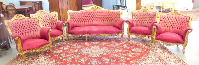 5 piece heavily carved salon set: Sofa and 4 arm chairs. Red fabric. Damages, repairs to gilding, stains