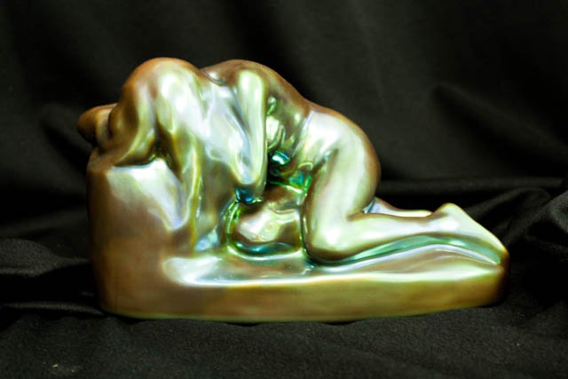 Zsolnay lustre porcelain "Reclining Nude on Rock": With oval gold stamp. Approx. 6.25" H x 9" x 4" D.