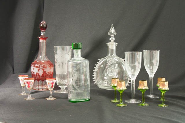 3 liquor bottles, 3 snifters, & goblets: Liquor bottles include Baccarat for Remy Martin, clear depicting man with lasso signed Neptune Elme, 3 bohemian glass snifters, etched glass goblet, stag in the forest and 5 green and gold brandy and