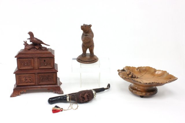 Lot of Black Forest carved wood items: Including, jewelry box with bird on lid, approx. 10" H x 8" W, pipe with stag carving, approx. 11", carved bear pencil holder, approx. 6", carved maple leaf music box, approx. 9" W.
