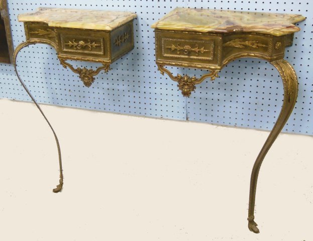 Pair of French brass & onyx top consoles: Early 20th century. Approx. 36" H x 16" W x 9" D.