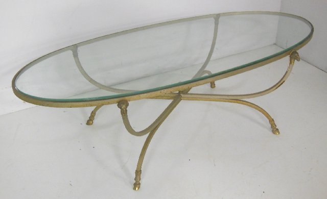 Brass & glass oval coffee table: With rams heads and hooves. Approx. 52" x 22.25" x 16" H.
