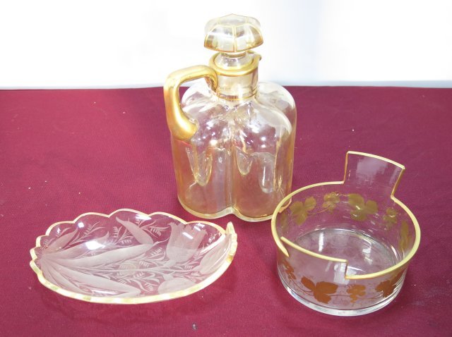 Three crystal pieces: Including water pitcher with stopper, wine coaster with gilt rim and motif, etched cut serving dish with gilt rim. Pitcher w/stopper H- approx 7 1/4", Dish W- approx. 7 1/4", Wine coaster D- approx. 6