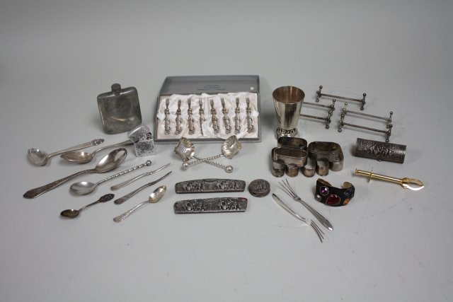 Lot of silver plate: Including: Cocktail forks, kiddush cup, tea strainer, napkin rings, jeweled cuff bracelet & pendant. Good condition.