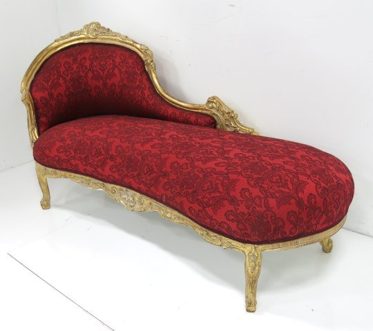 Mid century French style gold leaf chaise lounge: Red fabric. Approx. 75" W x 27" D x 40" H. Upholstery in good condition.