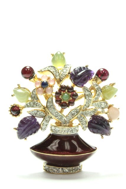 Judith Leiber brooch: Enamel & semi-precious stone in the form of a "Flowering Urn", gold tone frame, signed Judith Leiber at back. Approx. 2 1/8" x 2". Excellent condition.