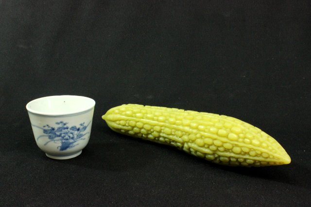 Two Chinese objects: Including porcelain cup and soapstone fruit. Approx. 11" long.