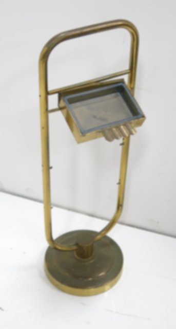Tommi Parzinger standing brass ashtray: Approx. 26" H. Provenance, Nathan & Janet Appleman Commission Ocean, NJ 1956. Brass pitted & oxidized, ashtray separating, glass chipped.