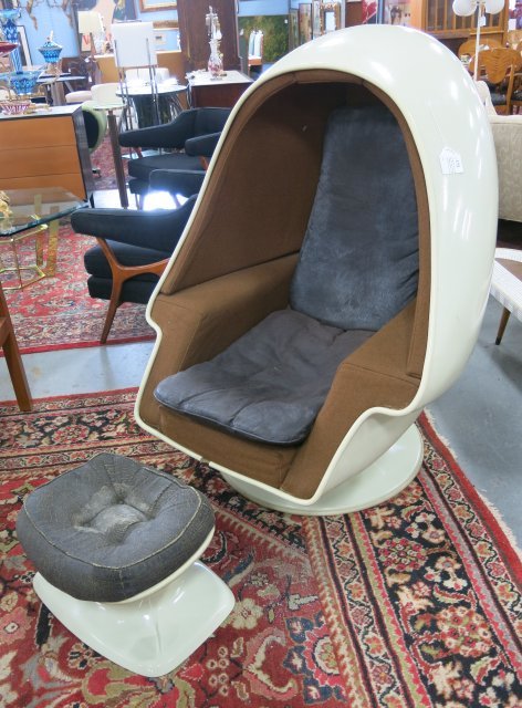 Arnio Eero Speaker chair & stool, Lee West Inc.: Fiberglass. Circa 1960. Chair approx. 50" H x 40" W x 42" D. Ottoman approx. 12"" H x 21" W x 15" D. Some marks, upholstery worn on stool loose cushions, worn.