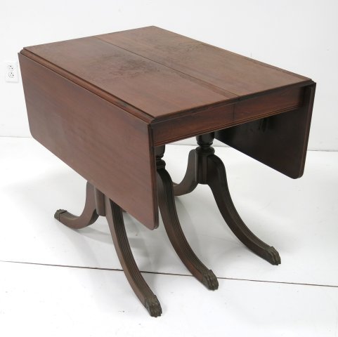 Mahogany drop leaf table with 3 pedestal legs: Ca. 1930's. Approx. 54" x 38" open. Needs refinishing, missing leaves