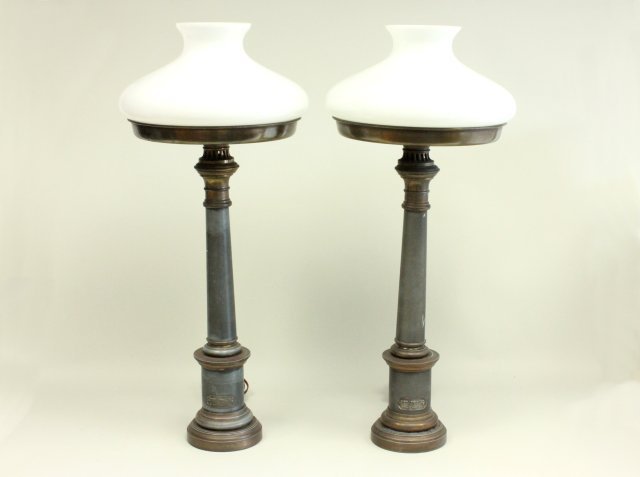 Pair of French Tole oil lamps: With milk glass shades. Labeled Lampe a Moderateur par Brevet d' Invention et de perfectionnement. 19th century. Approx. 31" H. From the Estate of Charlotte Thomas. Good condition.