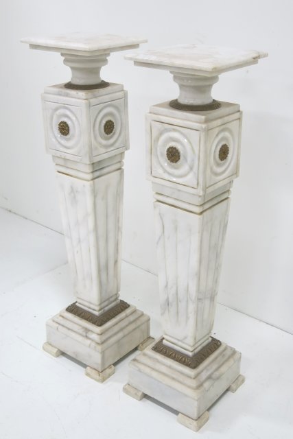 Pair of white marble pedestals: With bronze ormolu. Approx. 12" W x 12" D x 44" H. Good condition.