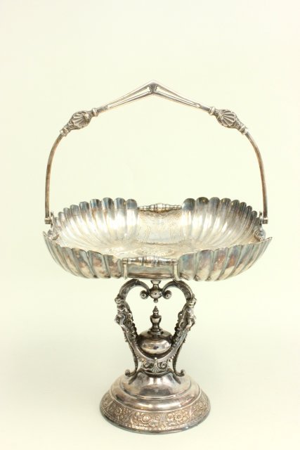Victorian silver plated compote by Wilcox: With swivel handle, pedestal adorned with "Cherubs". Approx. 25" H with handle up x 10" D. Good condition.