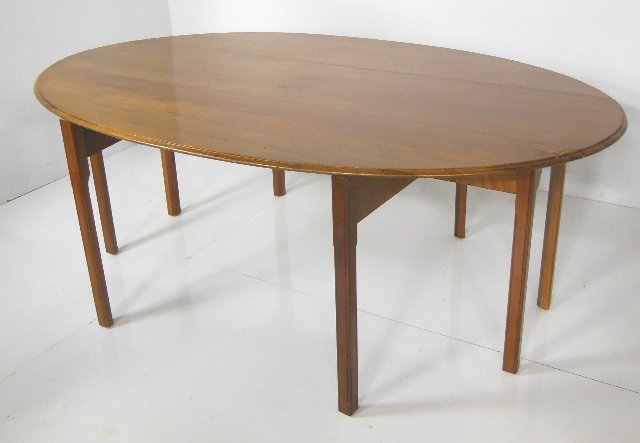 Hunt cherry wood drop leaf table by Baker: Approx. 29.5" H x 79" W. Drop leaves approx. 17" D x 17" W.