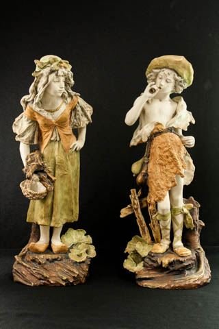 Pair Austrian Amphora porcelain young figures: Marked & numbered 4426. Approx. 23.5" H. Loss to feather in hat of boy.