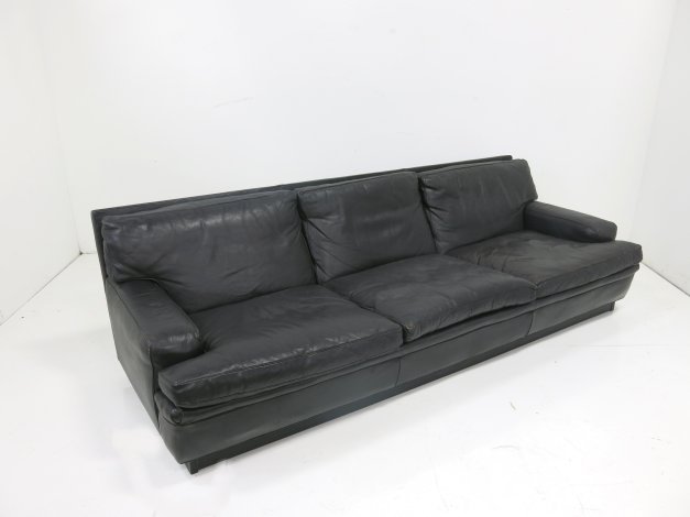 Arne Norell black leather couch: Circa 1960. Approx. 26" H x 92" W x 39" D. Property of a lady UN Plaza, NY. (4034) Minor wear on leather.