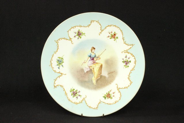 Hand painted French porcelain charger: Depicts seated artist. Signed P. Theobald. Crossed sword mark. Approx. 12" D. Good condition.