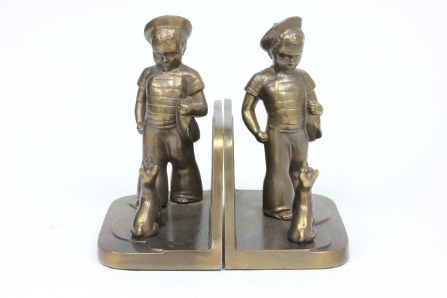 Pair of Frankart bookends: Depicting "Boy in Sailor Suit & Dog". Approx. 6 3/4" x 5 1/2". (3224)