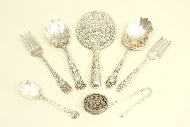 Group lot of sterling silver: Including: Spoon, 2 serving forks, serving spoon, large ornate serving fork, pill box, tongs, repousse hand mirror. Approx. 14.67 ozt (not including mirror).