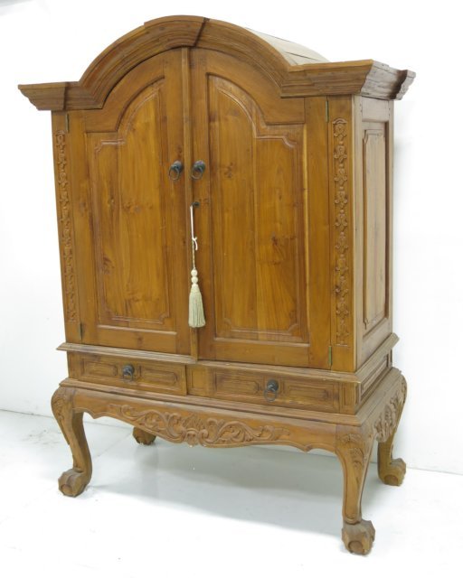 Carved Indonesian cabinet: 2 doors. Claw foot. Domed top. All pegged, paneled sides. Approx. 78" H x 58" W x 23 1/2" D.