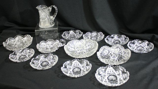 13 Pieces of Cut Glass: Including, pitcher approx. 5 1/2" H, 8 dishes approx. 6" D, candy dish approx. 7 1/2" W, 2 dishes approx. 8" D & 1 dish approx. 7" D.