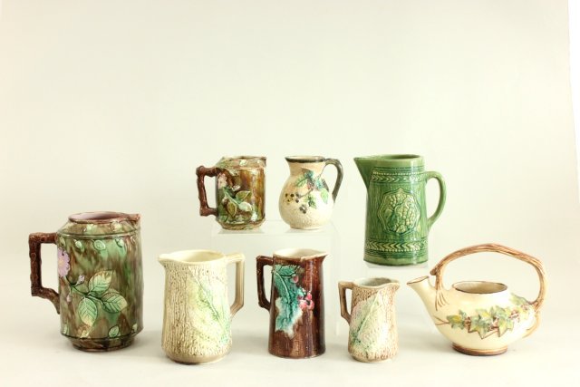 Lot of Majolica, pottery pitchers and one teapot: Eight pieces, largest approx. 10" H. Some with spider cracks