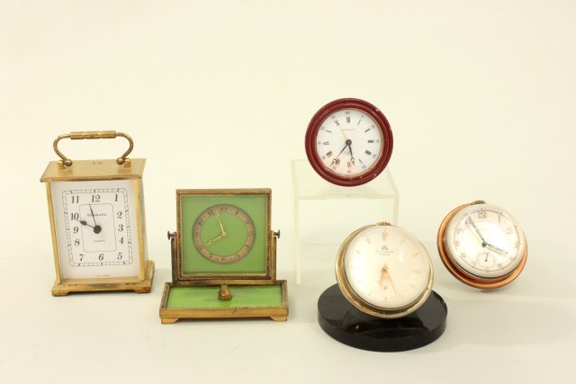 5 Desk Clocks: Including 2 - Bucherer 8 day 17 jewel crystal ball clocks & De Frece with second hand, 1 - round face Tiffany & Co 8 day 15 jewel alarm clock, 1 - green enameled 8 day alarm clock, deco & swivel stand