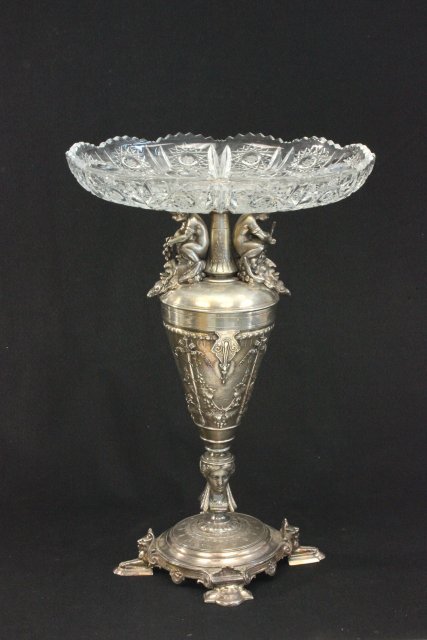 Figural Silver Plate & Glass Compote: Decorated with cherubs, satyr faces, & lion feet. Approx. 16 1/2" H. From a NYC collector's 40 year compilation. Crack on bottom.
